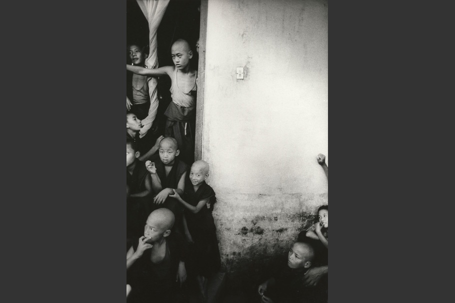 A group of young monks in a doorway.