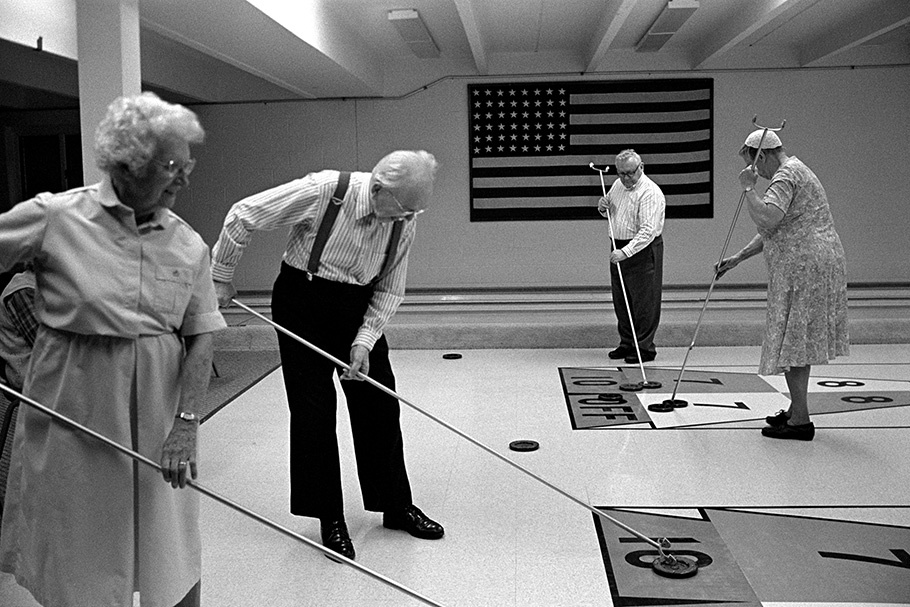 A group of senior citizens playing shuffleboard.