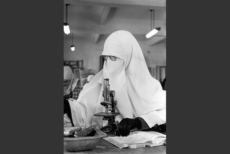 A woman with a microscope.