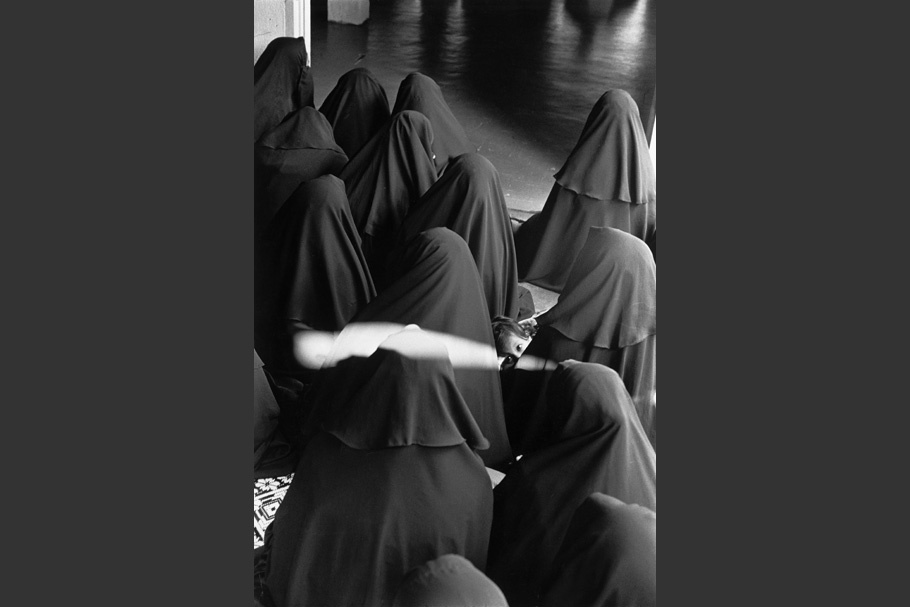 Women veiled in black.