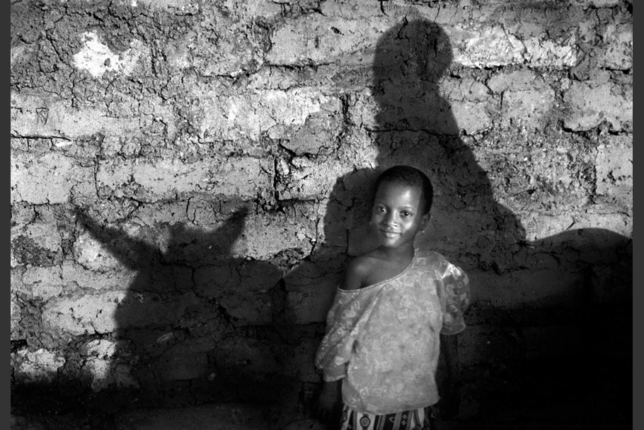 A child with a shadow of a donkey.
