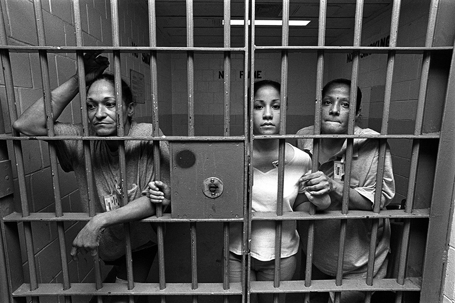 Three women in a jail cell.