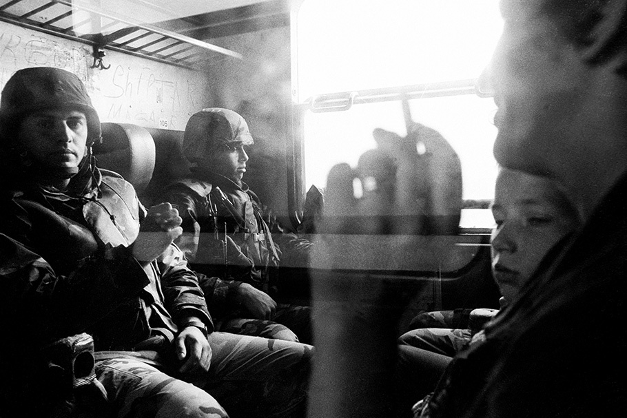 Soldiers sitting in a train compartment.
