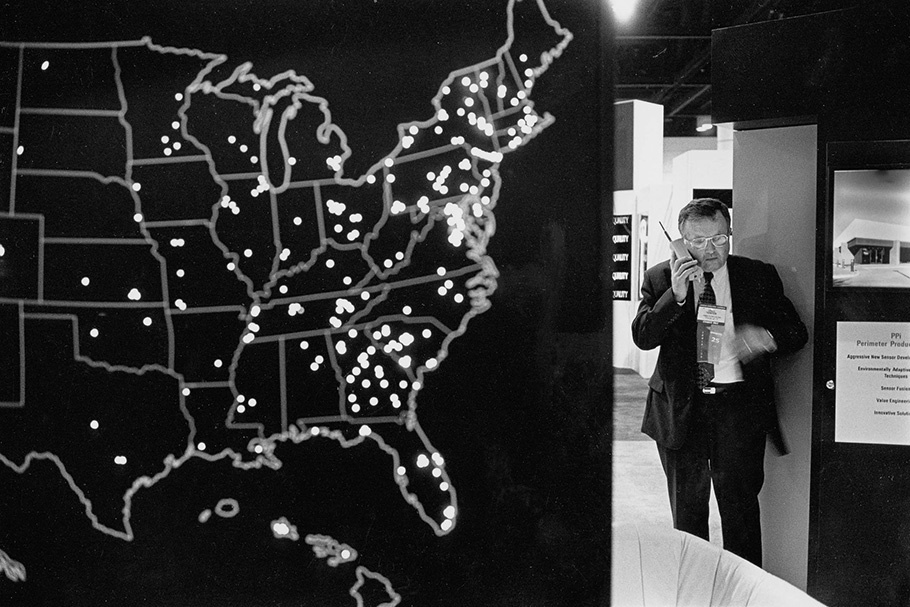 A man on the phone next to a US map.