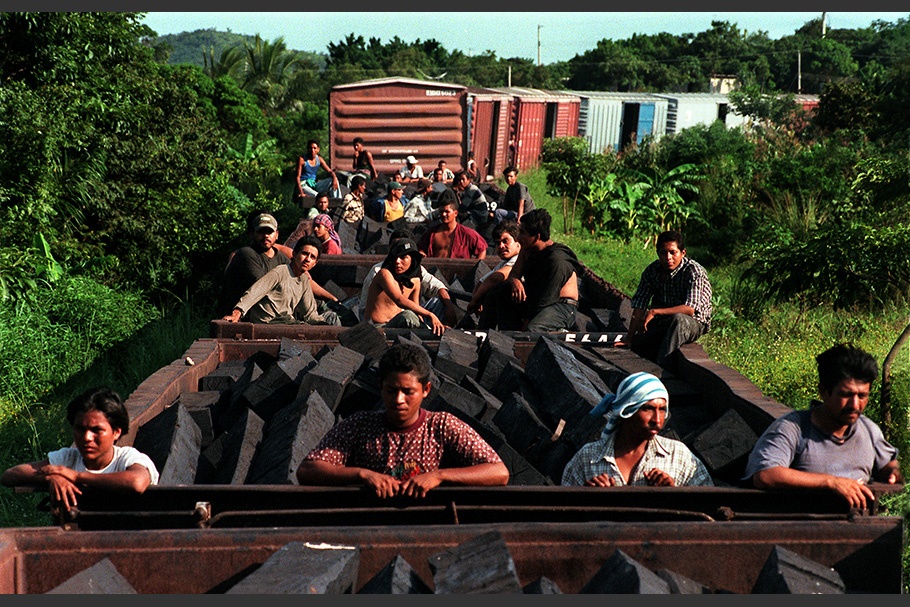 People riding on a freight train.