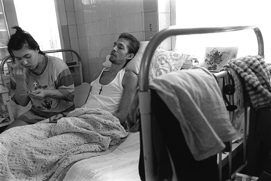 A couple on a hospital bed.