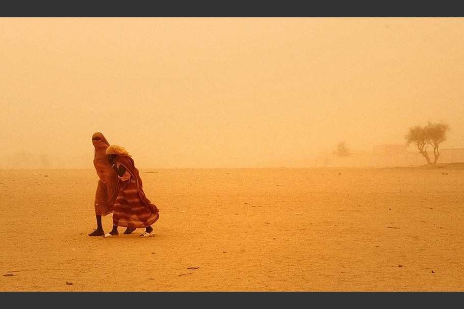 Two girls in a sandstorm.