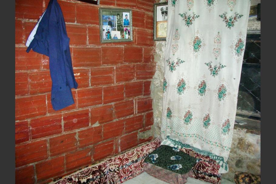 Interior with brick walls and hanging fabric.
