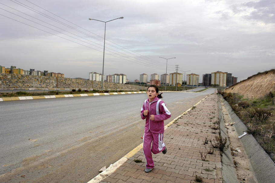 Girl running in pink track suit.