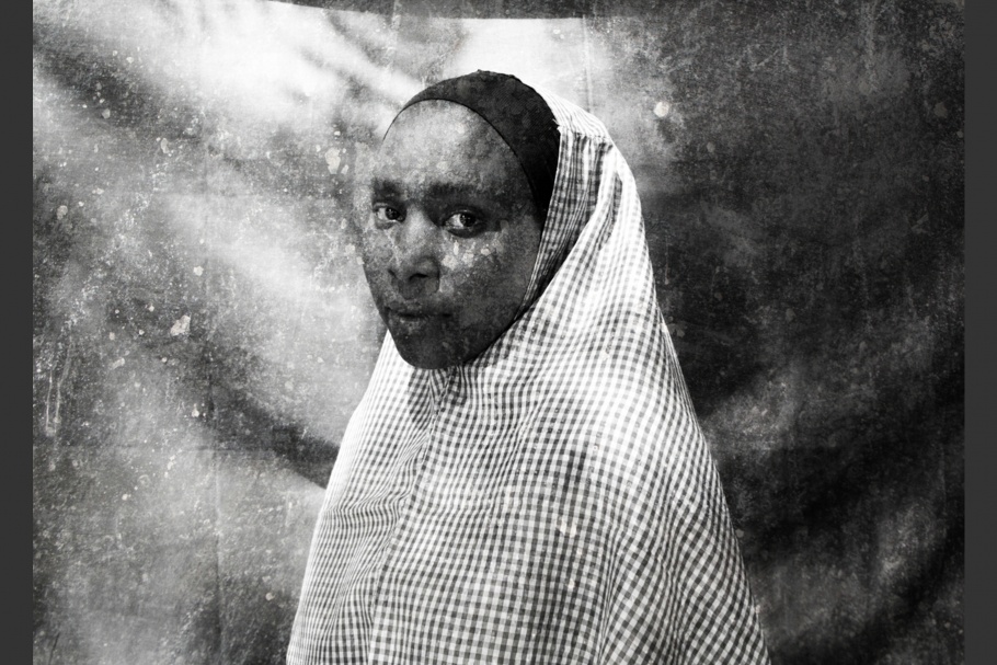 Portrait of a woman with head covering.