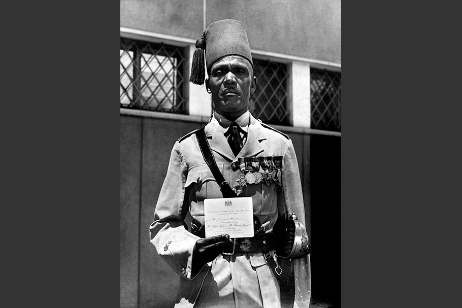 Nubian officer holding an invitation.