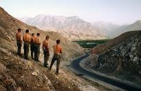 A row of men standing in the mountains.